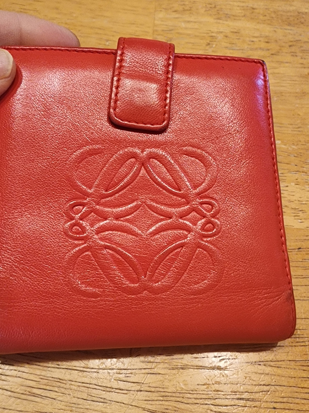 Loewe red Anagram bifold wallet crafted from Nappa leather.